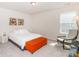Bright bedroom with white walls, a cozy bed with white linens, and a comfortable chair by the window at 4268 Coachwhip Ave, Lancaster, SC 29720