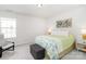 Cozy bedroom with a patterned bedspread, comfortable reading chair, and a decorative floral painting at 4268 Coachwhip Ave, Lancaster, SC 29720