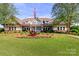 Community clubhouse with manicured lawn and American flag, providing a space for gatherings at 4268 Coachwhip Ave, Lancaster, SC 29720