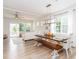 Bright dining area with wood table, bench, and white chairs, with view to doors to outdoor space at 4268 Coachwhip Ave, Lancaster, SC 29720
