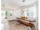 Bright dining area with wood table, bench, and white chairs with light fixture above table at 4268 Coachwhip Ave, Lancaster, SC 29720