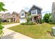 Charming two-story home featuring a manicured lawn, colorful landscaping, and a welcoming front porch at 4268 Coachwhip Ave, Lancaster, SC 29720
