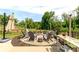 Outdoor patio with a fire pit, seating, a bar area, hammock, and shade umbrella for relaxing and entertaining at 4268 Coachwhip Ave, Lancaster, SC 29720