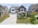 Inviting two-story home features a well-maintained lawn, stone accents, a two-car garage, and charming curb appeal at 4268 Coachwhip Ave, Lancaster, SC 29720