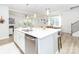 Bright kitchen with white cabinets, stainless steel dishwasher, island and view to the dining area at 4268 Coachwhip Ave, Lancaster, SC 29720