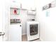 Functional laundry room with washer, dryer, and shelving for storage and organization at 4268 Coachwhip Ave, Lancaster, SC 29720