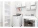 Well-organized laundry room equipped with washer, dryer, and ample shelving for storage solutions at 4268 Coachwhip Ave, Lancaster, SC 29720