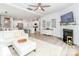 Open concept living room with fireplace, white couch and ottoman with view to kitchen at 4268 Coachwhip Ave, Lancaster, SC 29720