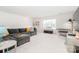 Spacious living room with a large sectional sofa, light carpet and bright natural light from the window at 4268 Coachwhip Ave, Lancaster, SC 29720