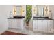Elegant bathroom showcasing dual vanities with dark countertops and eye-catching gold fixtures at 4900 Doris Ave, Charlotte, NC 28205