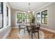 Bright dining room with ample natural light, modern light fixtures, and views of the surrounding landscape at 4900 Doris Ave, Charlotte, NC 28205