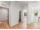 Bright hallway boasts hardwood floors, crisp white walls, and neutral doors at 4900 Doris Ave, Charlotte, NC 28205