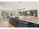 Open-concept kitchen featuring a large marble island, hardwood floors, and modern design at 4900 Doris Ave, Charlotte, NC 28205