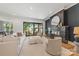 Bright living room featuring a fireplace, sleek furniture, and access to outdoor space through sliding glass doors at 4900 Doris Ave, Charlotte, NC 28205