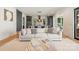 Inviting living room with a large sofa, ottoman, and views into the modern kitchen area at 4900 Doris Ave, Charlotte, NC 28205