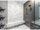 Close up of a modern shower featuring marble tiling and sleek fixtures at 4900 Doris Ave, Charlotte, NC 28205