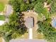 Aerial view of a home featuring a backyard with a deck, fire pit, garden, and mature trees at 5499 Angus Dr, Midland, NC 28107