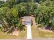 Aerial view of a two-story home with a long driveway and surrounded by mature trees at 5499 Angus Dr, Midland, NC 28107