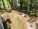 Private backyard featuring a deck with outdoor seating, fire pit and landscaped garden area at 5499 Angus Dr, Midland, NC 28107