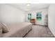 Cozy bedroom with neutral walls, carpet, two windows and a charming writing desk at 5499 Angus Dr, Midland, NC 28107