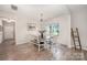 Bright dining room with a modern chandelier, table with bench, and wood-style floors at 5499 Angus Dr, Midland, NC 28107