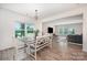 Open dining room with stylish chandelier, hardwood floors, and ample natural light at 5499 Angus Dr, Midland, NC 28107
