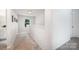 Upstairs hallway showcasing neutral carpet and trim, plus ample natural light at 5499 Angus Dr, Midland, NC 28107