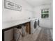 Functional laundry room includes washer, dryer, countertop and stylish baskets at 5499 Angus Dr, Midland, NC 28107