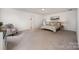 Spacious bedroom with neutral carpet, ample natural light, and a comfortable seating area at 5499 Angus Dr, Midland, NC 28107
