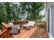 Relaxing wood deck with patio seating overlooking lush trees at 5499 Angus Dr, Stanfield, NC 28163
