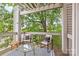 Enjoy outdoor living on this cozy balcony surrounded by lush greenery and comfortable seating at 558 Oakland Ave, Charlotte, NC 28204