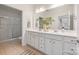 A bright bathroom with a double sink vanity and a separate shower room at 558 Oakland Ave, Charlotte, NC 28204