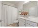 A minimalist bathroom features a single sink vanity and shower with curtain at 558 Oakland Ave, Charlotte, NC 28204