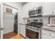 A modern kitchen features stainless steel appliances and a stackable washer/dryer at 558 Oakland Ave, Charlotte, NC 28204