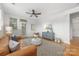 Comfortable living room featuring a stylish tan sofa, decorative rug, and a modern ceiling fan at 558 Oakland Ave, Charlotte, NC 28204