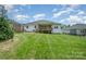 Spacious backyard features a well-maintained lawn and a charming covered deck, perfect for outdoor entertaining at 7739 Village Pkwy, Locust, NC 28097