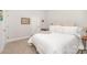 A well-lit bedroom featuring neutral tones, soft carpeting, and ample space for relaxation and personalization at 7739 Village Pkwy, Locust, NC 28097