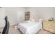 Comfortable bedroom with soft bedding, natural light, and space-saving shelving for books and decorative items at 7739 Village Pkwy, Locust, NC 28097