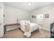 Cozy bedroom with plush carpeting, natural light, and a charming desk space for work or study at 7739 Village Pkwy, Locust, NC 28097