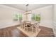 Elegant dining room featuring hardwood floors, wainscoting, contemporary lighting and sunlit windows at 7739 Village Pkwy, Locust, NC 28097
