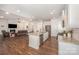 Open-concept kitchen features a granite island, stainless steel appliances, and seamless flow into the living area at 7739 Village Pkwy, Locust, NC 28097