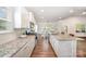 Modern kitchen with stainless steel appliances, white cabinets, granite countertops, and hardwood floors at 7739 Village Pkwy, Locust, NC 28097