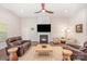 Inviting living room boasts a fireplace, hardwood floors, recessed lighting, and stylish furniture at 7739 Village Pkwy, Locust, NC 28097