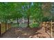 Spacious backyard featuring mature trees, a screened porch, and a privacy fence at 807 Water Wheel Ct, Charlotte, NC 28209