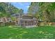Spacious backyard features a large lawn, a playhouse, and a screened-in porch at 807 Water Wheel Ct, Charlotte, NC 28209