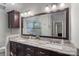 Bright bathroom with double sink vanity featuring granite counters and a tiled shower at 807 Water Wheel Ct, Charlotte, NC 28209