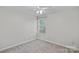 This bedroom features neutral walls, carpet, a ceiling fan, and a window with blinds at 807 Water Wheel Ct, Charlotte, NC 28209