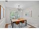 Bright dining room with modern light fixture, window and wood table with seating at 807 Water Wheel Ct, Charlotte, NC 28209