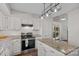 Bright kitchen featuring white cabinets, granite countertops, and stainless steel appliances at 807 Water Wheel Ct, Charlotte, NC 28209