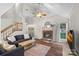 Bright living room with vaulted ceilings, brick fireplace, and access to the outdoor deck at 807 Water Wheel Ct, Charlotte, NC 28209